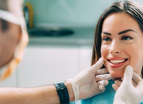 Dentist looking at smiling patient's teeth