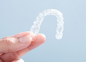 Patient holding clear aligner