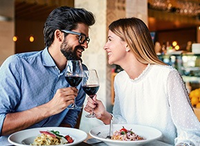 Couple smiling at each other on date in restaurant