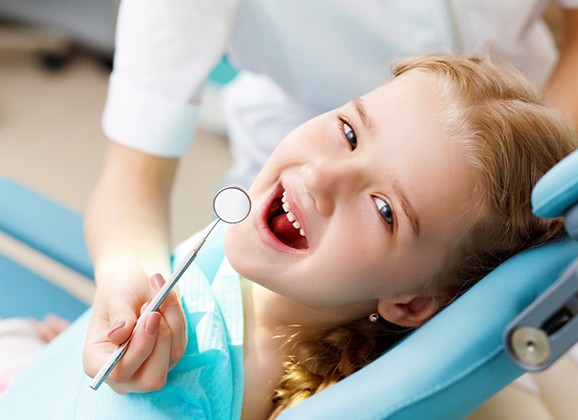 a child visiting their dentist for a cleaning