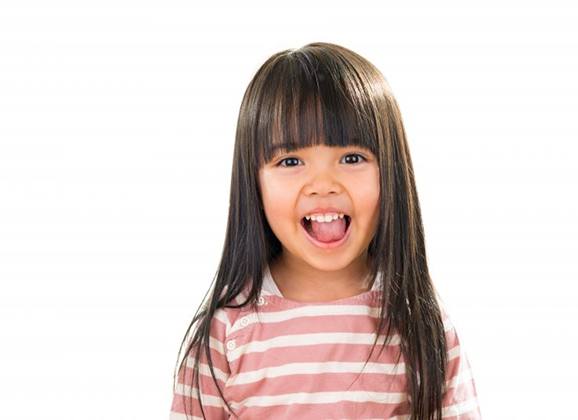 a closeup of a child’s smile