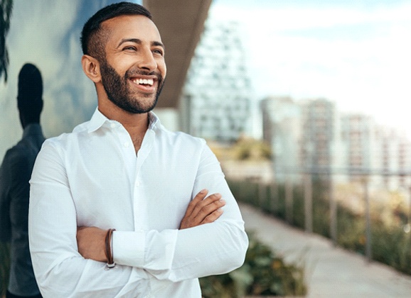 Man smiling with healthy teeth outside