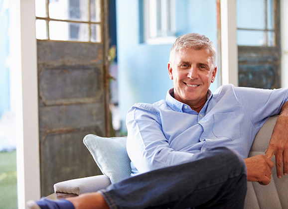 Man with dentures in Brooklyn smiling