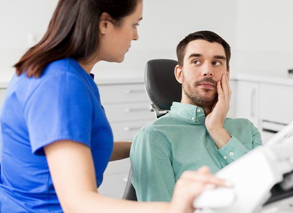 Man in dental chair for emergency dentistry treatment