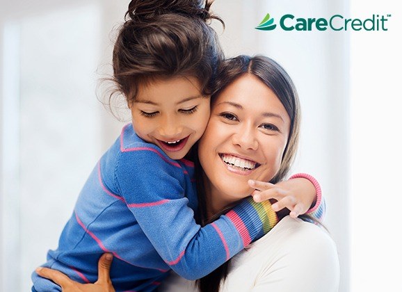 Woman and young daughter smiling together