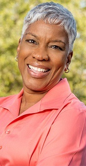 Woman smiling after emergency dentistry