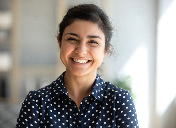 Woman with veneers in Brooklyn smiling