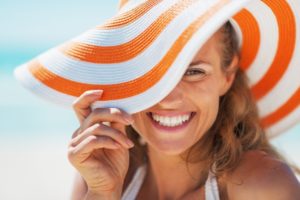 Smiling woman in sun hat without gum disease