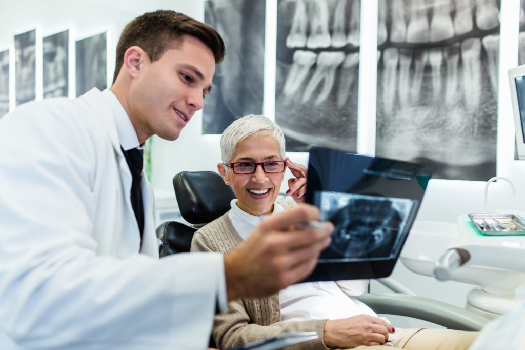 Periodontist showing patient their X-ray