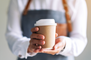 a person holding a cup of coffee 