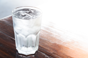 a glass of ice cubes in water
