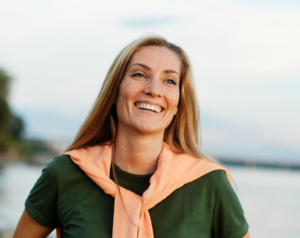 a person smiling in the sunlight